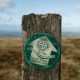 A wooden post with a sign on it, in Pembrokeshire
